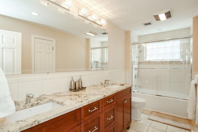 bathroom with toilet, a sink, and visible vents