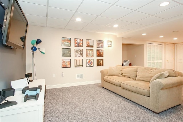 living area featuring visible vents, baseboards, recessed lighting, a drop ceiling, and carpet floors