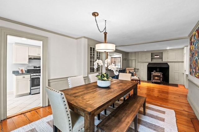 2 Andover St Unit A, Salem, MA 01970 - dining area featuring a wood stove, light wood-type flooring, and crown molding