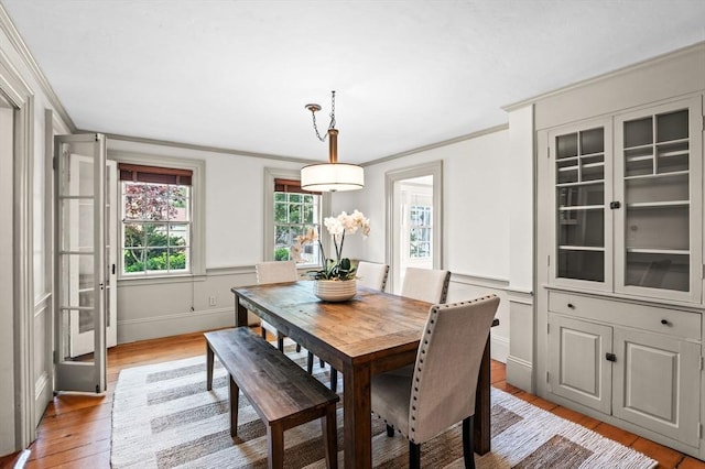 2 Andover St Unit A, Salem, MA 01970 - dining space featuring crown molding, light wood finished floors, and wainscoting