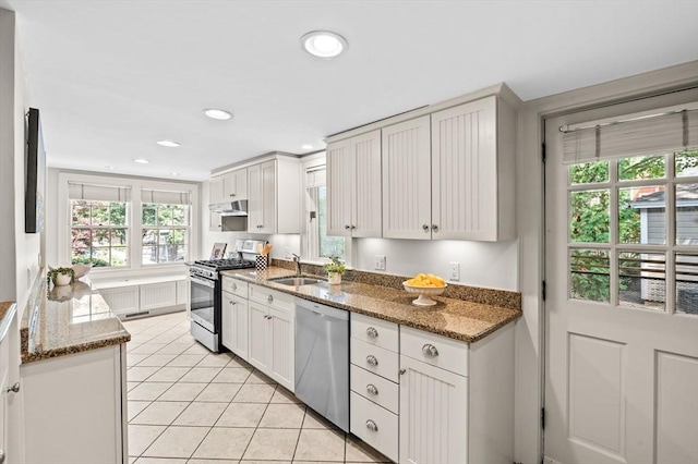 2 Andover St Unit A, Salem, MA 01970 - kitchen featuring appliances with stainless steel finishes, plenty of natural light, light tile patterned floors, recessed lighting, and stone countertops