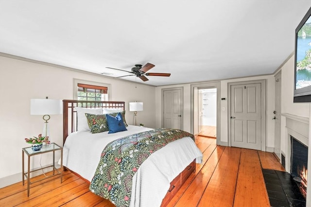 2 Andover St Unit A, Salem, MA 01970 - bedroom with a fireplace with flush hearth, light wood-type flooring, and ceiling fan