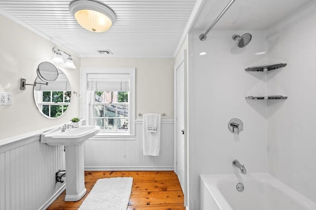 2 Andover St Unit A, Salem, MA 01970 - bathroom with wood finished floors, wainscoting, tub / shower combination, and crown molding