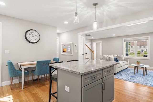 30 Oak Meadow Pl Unit 30, Bridgewater, MA 02324 - kitchen featuring gray cabinetry, light wood finished floors, pendant lighting, a kitchen bar, and recessed lighting