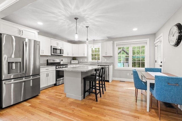 30 Oak Meadow Pl Unit 30, Bridgewater, MA 02324 - kitchen featuring stainless steel appliances, recessed lighting, light wood-type flooring, a kitchen bar, and white cabinetry