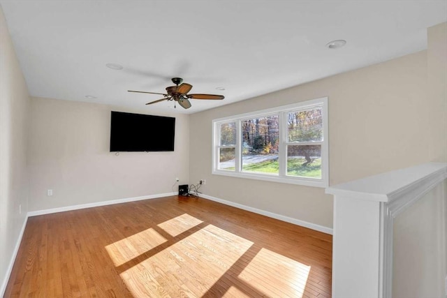 unfurnished room featuring baseboards, a ceiling fan, and wood finished floors