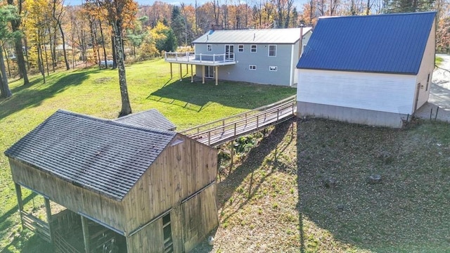 exterior space featuring a wooden deck and a lawn