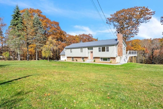 rear view of property with stairs, entry steps, a lawn, and a chimney