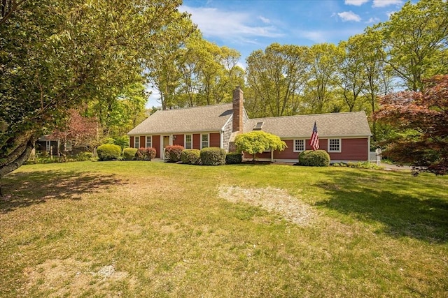 ranch-style house featuring a front yard and a chimney