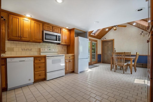 kitchen featuring white appliances, light countertops, tasteful backsplash, brown cabinets, and lofted ceiling