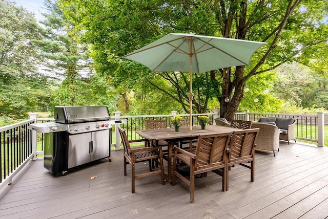 wooden deck featuring grilling area and outdoor dining space