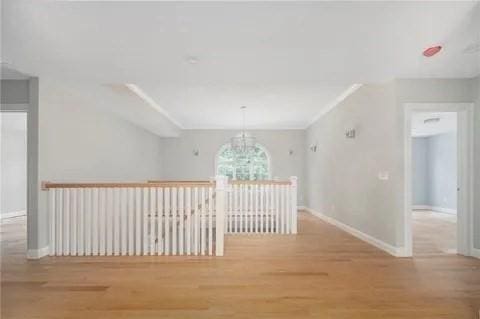 70 Shady Ln, Burrillville, RI 02859 - hall featuring a chandelier, wood finished floors, baseboards, and healthy amount of natural light