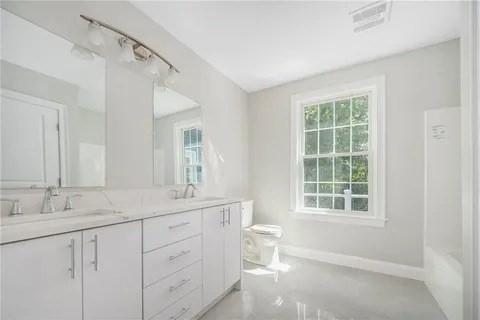 70 Shady Ln, Burrillville, RI 02859 - full bathroom featuring healthy amount of natural light, double vanity, toilet, and baseboards