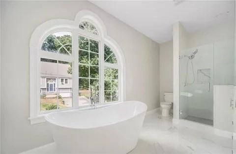 70 Shady Ln, Burrillville, RI 02859 - bathroom with a shower stall, a freestanding tub, toilet, and baseboards