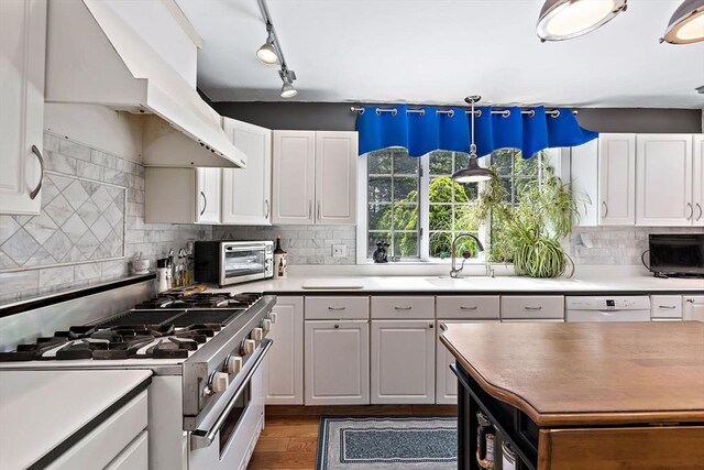 589 Depot St, Harwich, MA 02645 - kitchen featuring white cabinets, a toaster, dishwasher, stainless steel range with gas stovetop, and custom range hood
