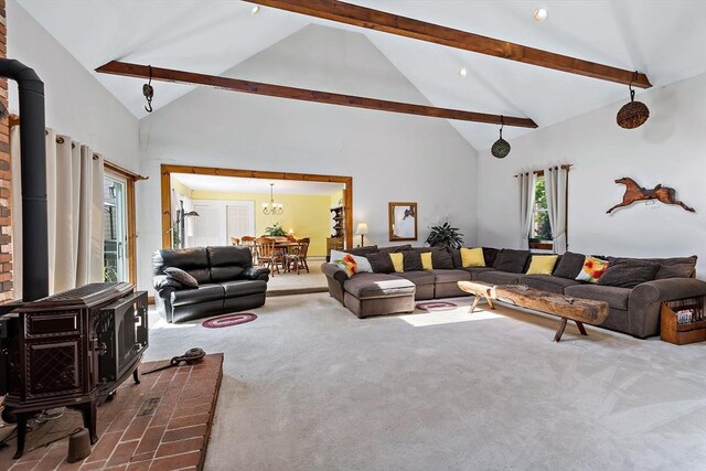 589 Depot St, Harwich, MA 02645 - living room with dark carpet, a wood stove, and beam ceiling