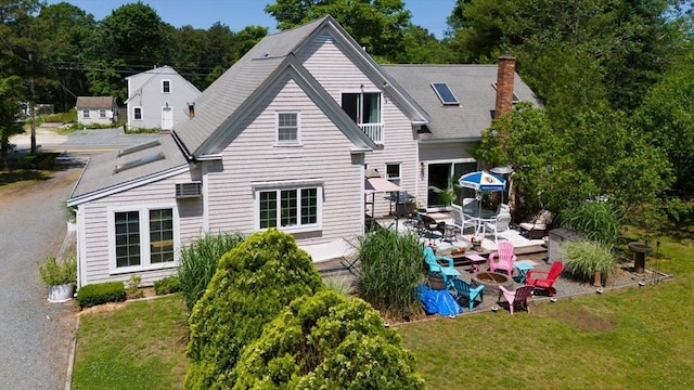589 Depot St, Harwich, MA 02645 - back of house featuring a lawn and a patio area