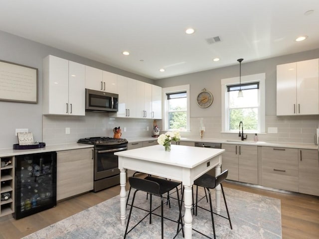 447 Frankfort St Unit 3, Boston, MA 02128 - kitchen with stainless steel appliances, decorative backsplash, light wood-style flooring, light countertops, and recessed lighting