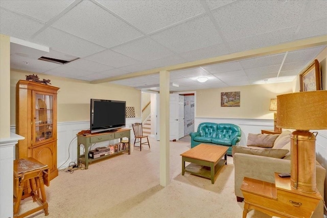 17 Chadwick Ct Unit 17, Mashpee, MA 02649 - living area featuring a paneled ceiling, a wainscoted wall, stairs, and light colored carpet