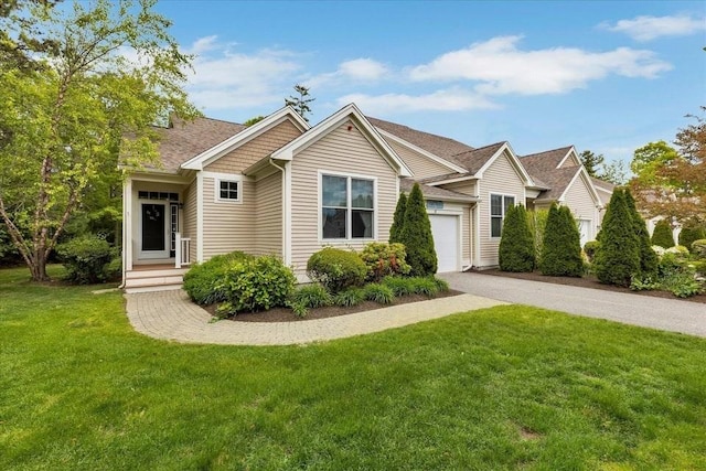 17 Chadwick Ct Unit 17, Mashpee, MA 02649 - view of front of house with a front yard, asphalt driveway, and a garage