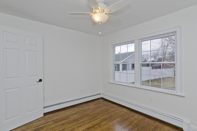 unfurnished room featuring dark wood-style floors, baseboard heating, and a ceiling fan