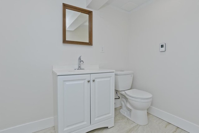 bathroom with toilet, baseboards, and vanity