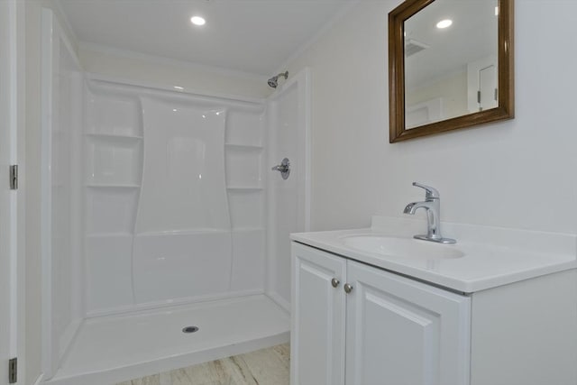 bathroom with recessed lighting, visible vents, a shower, and vanity