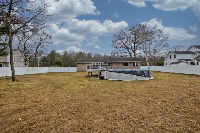 back of property featuring a fenced backyard, a fenced in pool, and a yard