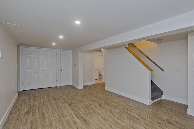 finished basement with baseboards, stairway, wood finished floors, and recessed lighting