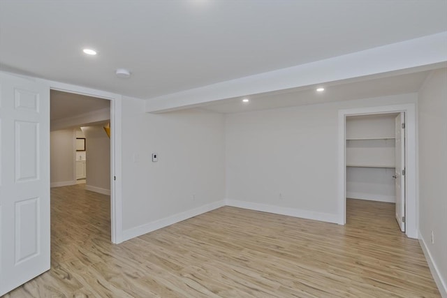 unfurnished room with light wood-style flooring, baseboards, and recessed lighting