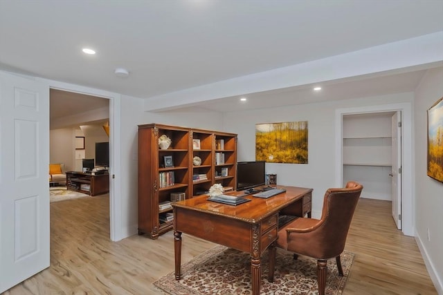 office area with baseboards, light wood finished floors, and recessed lighting