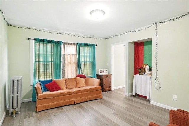 80-82 Kenyon St, Springfield, MA 01109 - living area with radiator, light wood-type flooring, and baseboards