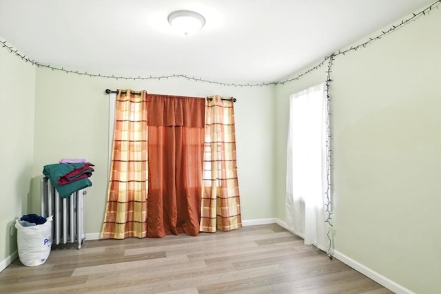 80-82 Kenyon St, Springfield, MA 01109 - spare room featuring radiator heating unit, baseboards, and wood finished floors