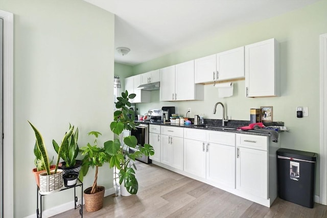80-82 Kenyon St, Springfield, MA 01109 - kitchen with a sink, electric range, white cabinetry, light wood-style floors, and under cabinet range hood