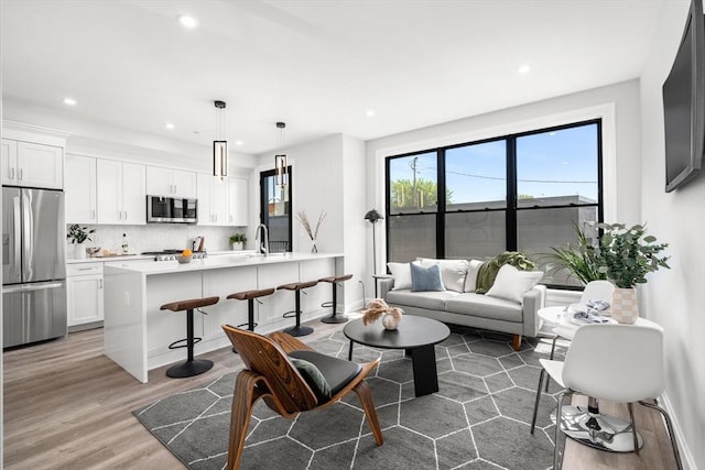 523 2nd St Unit 303, Everett, MA 02149 - living room featuring wood finished floors, recessed lighting, and baseboards