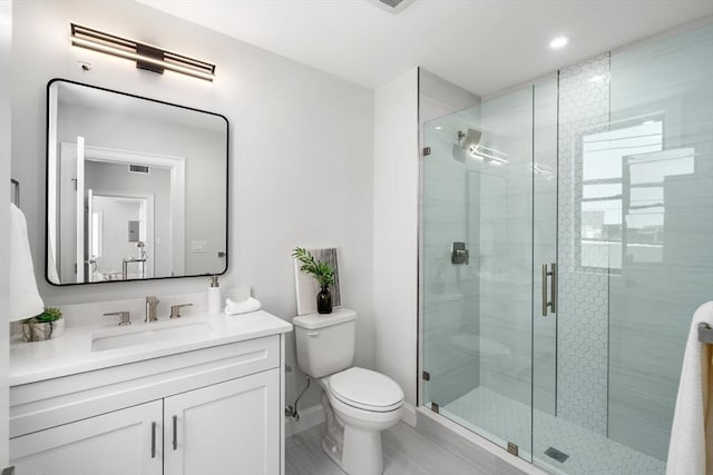 523 2nd St Unit 303, Everett, MA 02149 - bathroom featuring a shower stall, toilet, vanity, and baseboards