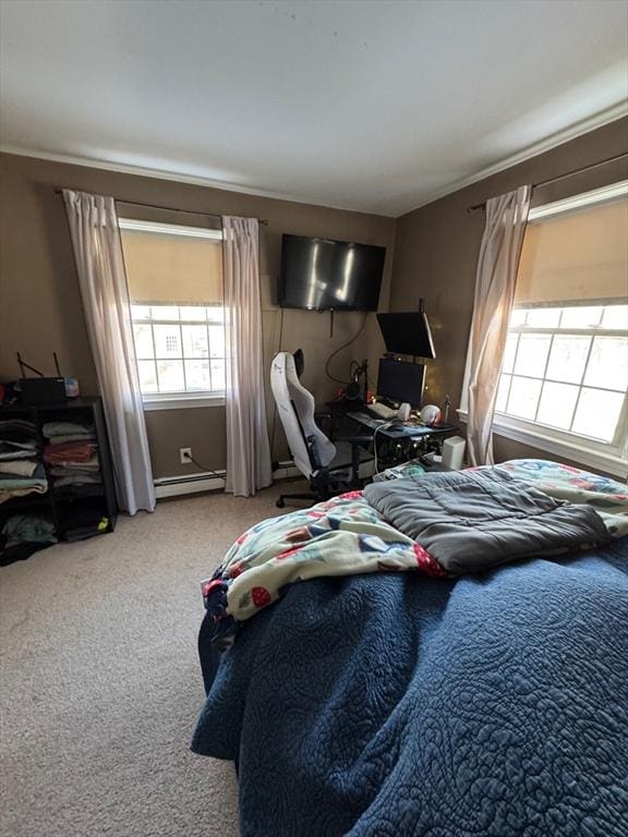 bedroom featuring a baseboard heating unit and carpet