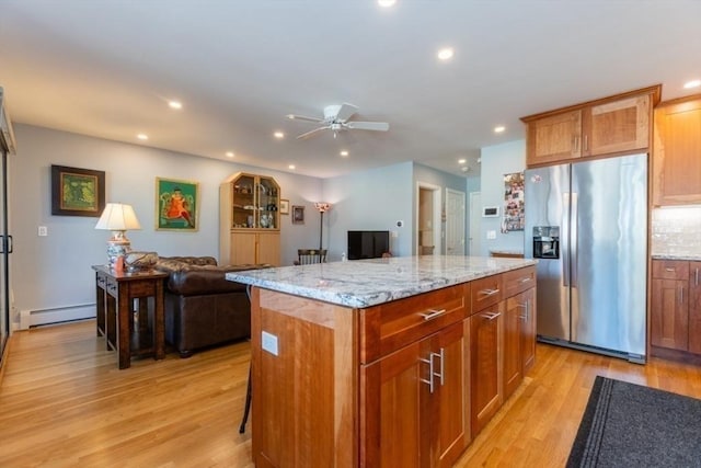 935 Washington St Unit 12, Newton, MA 02460 - kitchen featuring stainless steel fridge, a baseboard heating unit, light wood-style flooring, open floor plan, and recessed lighting