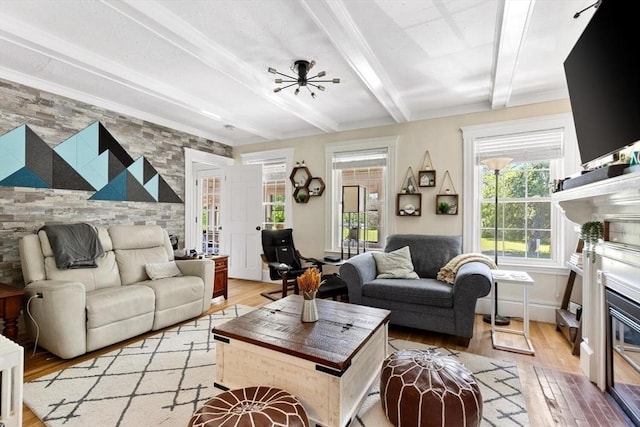 2218 Mystic Valley Pkwy, Medford, MA 02155 - living area featuring a glass covered fireplace, light wood-type flooring, beam ceiling, and french doors