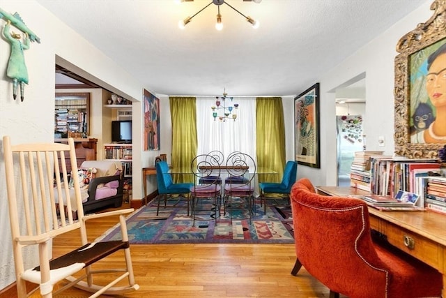 2218 Mystic Valley Pkwy, Medford, MA 02155 - dining room featuring wood finished floors and a chandelier