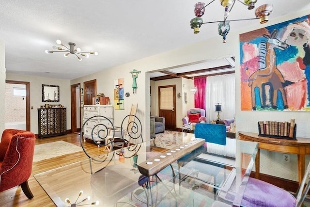 2218 Mystic Valley Pkwy, Medford, MA 02155 - dining room featuring a chandelier, wood finished floors, and baseboards