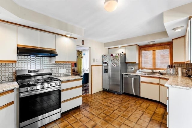 2218 Mystic Valley Pkwy, Medford, MA 02155 - kitchen featuring stainless steel appliances, under cabinet range hood, a sink, decorative backsplash, and white cabinets