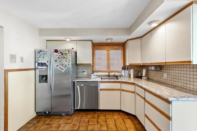 2218 Mystic Valley Pkwy, Medford, MA 02155 - kitchen featuring appliances with stainless steel finishes, a sink, decorative backsplash, light tile patterned floors, and light stone counters