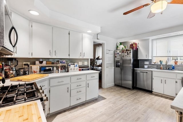 2218 Mystic Valley Pkwy, Medford, MA 02155 - kitchen with stainless steel appliances, a sink, backsplash, light countertops, and recessed lighting