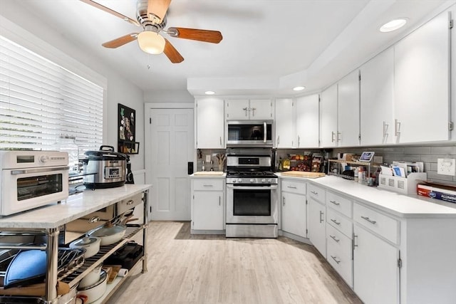 2218 Mystic Valley Pkwy, Medford, MA 02155 - kitchen with appliances with stainless steel finishes, light countertops, ceiling fan, light wood-type flooring, and recessed lighting