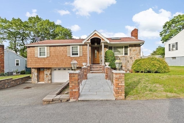 196 Plymouth Ave, Quincy, MA 02169 - ranch-style home featuring stone siding, asphalt driveway, a garage, a chimney, and a front lawn