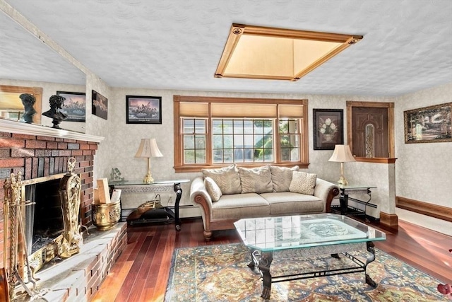 196 Plymouth Ave, Quincy, MA 02169 - living area with hardwood / wood-style flooring, a textured ceiling, a fireplace, baseboards, and wallpapered walls