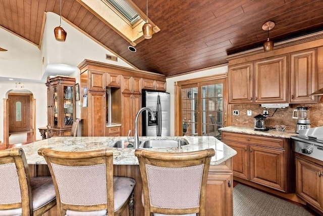 196 Plymouth Ave, Quincy, MA 02169 - kitchen with a sink, wood ceiling, stainless steel fridge with ice dispenser, light stone counters, and a skylight