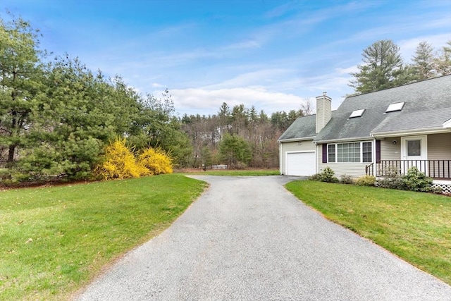 view of home's exterior with a garage, a lawn, and covered porch