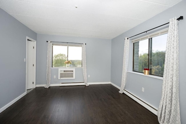 unfurnished room with baseboard heating, a wall mounted AC, a baseboard heating unit, a wealth of natural light, and dark wood finished floors